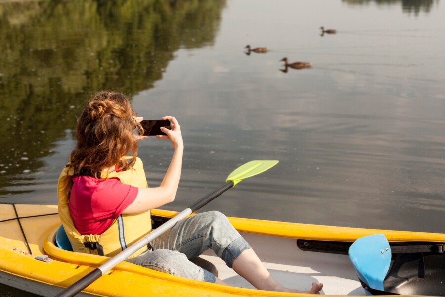 woman-staying-kayak-taking-photos-best covers for kayaks