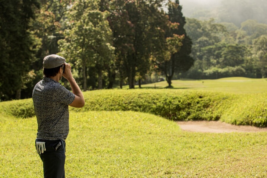 A man with golf rangefinder observing the game-best golf rangefinder