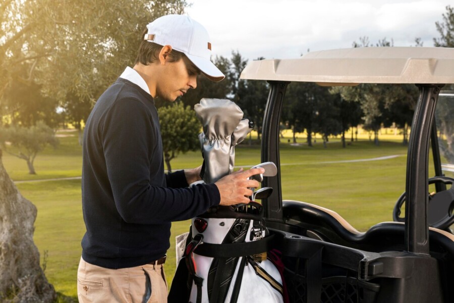 side-view-man-putting-clubs-golf-cart_best golf apps